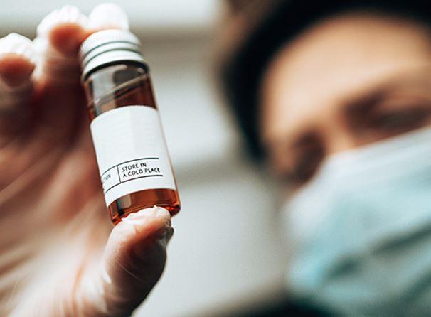 Woman reading medicine tube