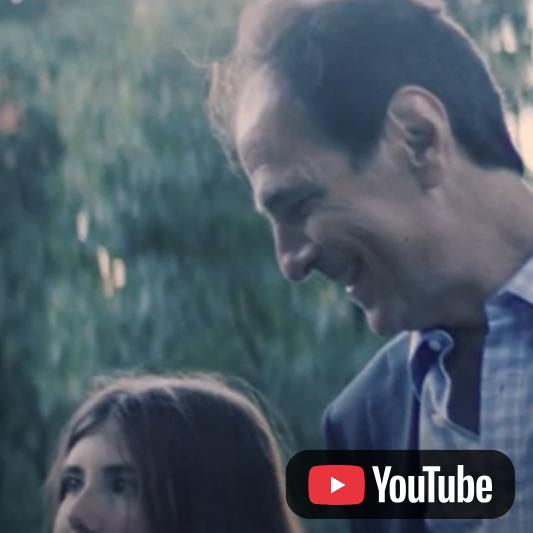 Video thumbnail featuring an adult and a child outdoors, with a YouTube icon in the lower-right corner.