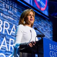Hoda Kotb behind a podium giving a speech